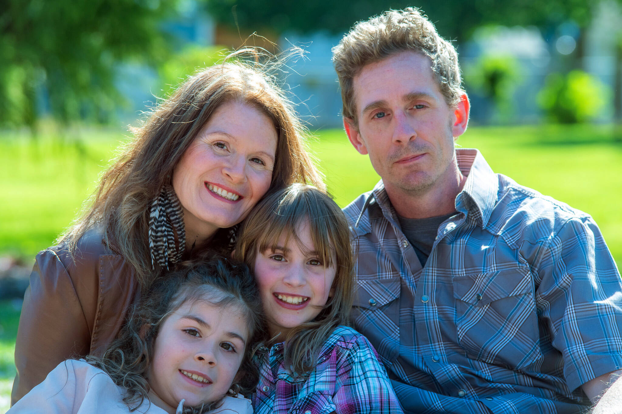 The Hanshaw family is struggling under the weight of emotional and financial stressors brought by the recent diagnoses by doctors at Seattle Children’s Hospital that have finally answered the question of why Ember, center, has always been frail. Shown with Ember are her parents, Jennifer and Tim Hanshaw, and 9-year-old sister Lena, who shares a hereditary condition with her father and sister. (Emily Matthiessen/Olympic Peninsula News Group)