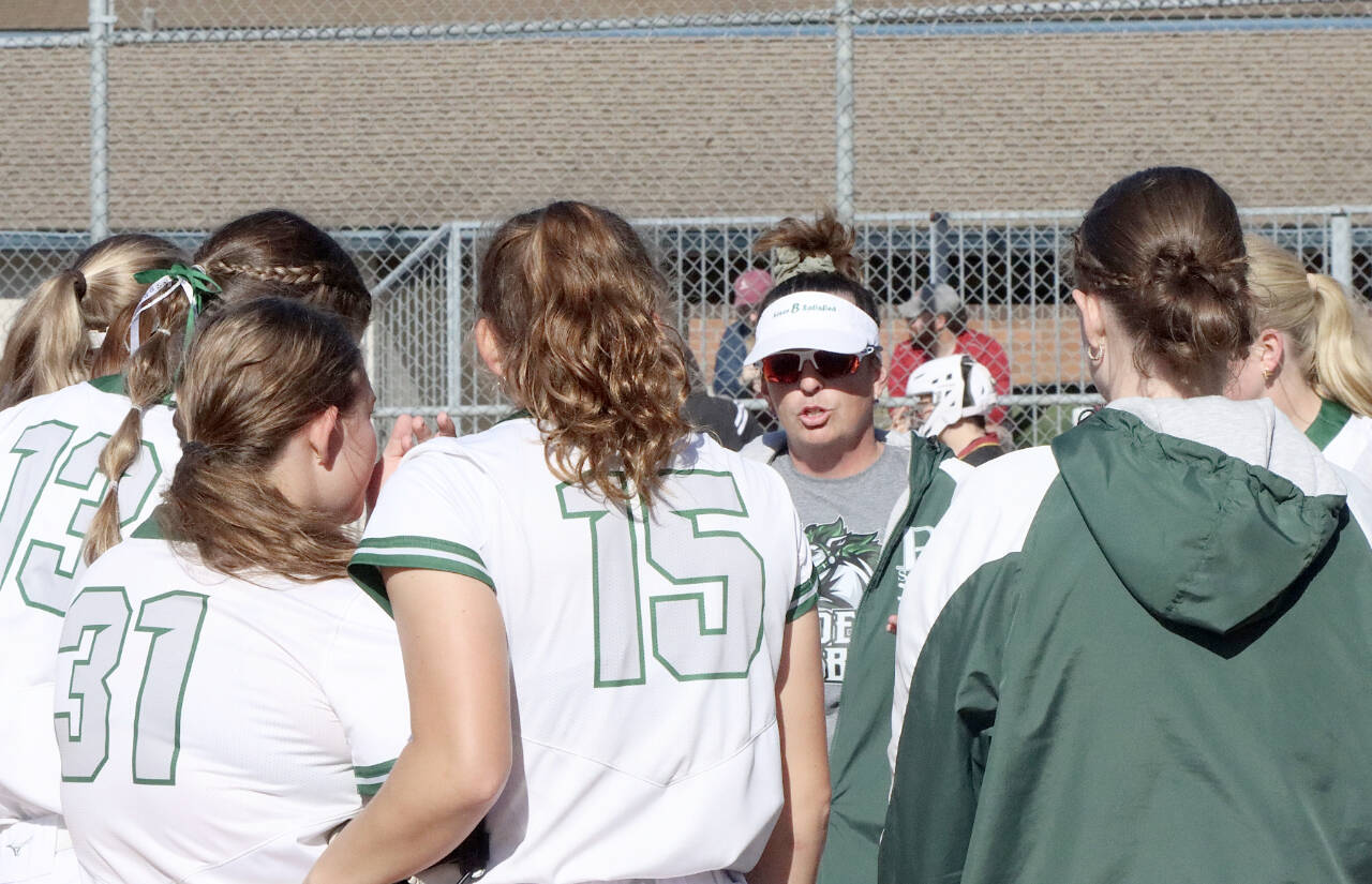 Coach Morgan Worthington talks to her players between innings at a game last week at Dry Creek Elementary. The Roughriders go in to the state tournament Friday ranked No. 3 in the state. (Dave Logan/for Peninsula Daily News)