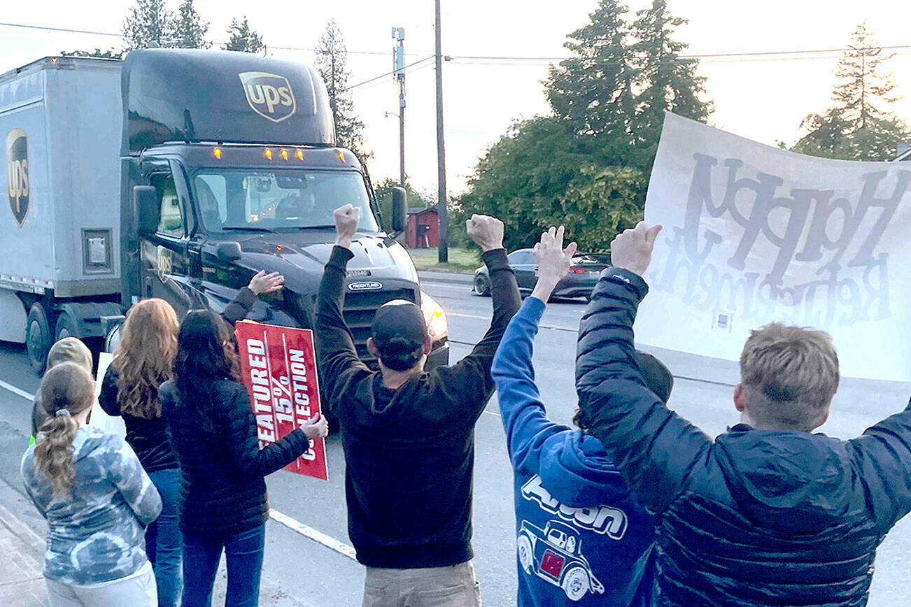 Family, friends and co-workers give Corey Alton a spirited send-off to celebrate the final shift of the Port Angeles driver's 36 years with UPS. Alton drove about 3.5 million miles over the course of his career without an accident or a ticket. (Paula Hunt/Peninsula Daily News)