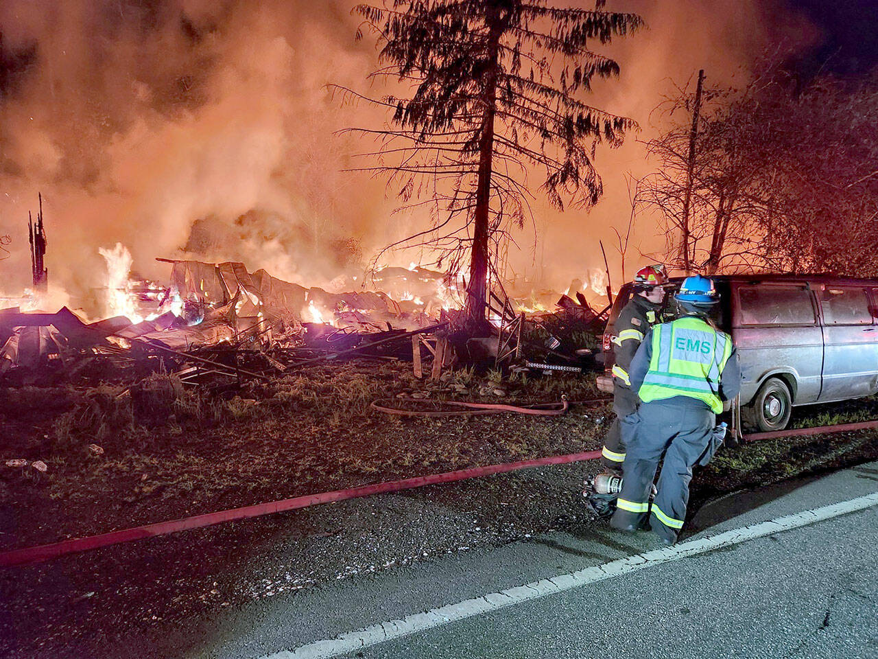 First responders assess a structure fire Thursday night on U.S. Highway 101 between Quilcene and Brinnon. (Jefferson County Sheriff’s Office via X)