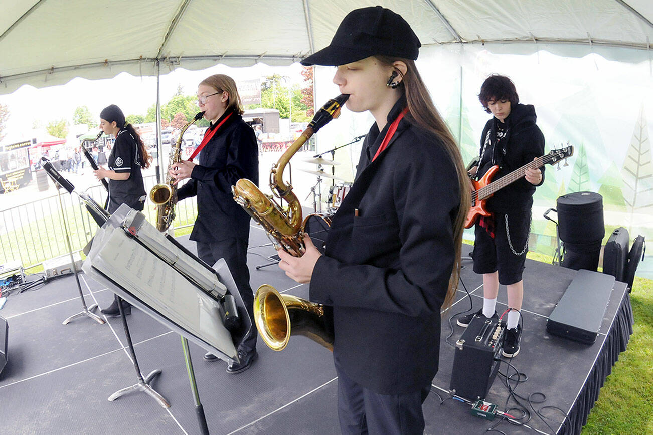 Members of the Crescent High School Jazz Band, from left, Lilly Svenson, Axel Teel, Avery Griffin and Samuel Kitts, perform as Friday’s opening act at the Juan de Fuca Festival of the Arts at Vern Burton Community Center in Port Angeles. Dozens of musical acts, along with food, activities and a craft fair are highlighted across five stages during the three-day festival. (Keith Thorpe/Peninsula Daily News)