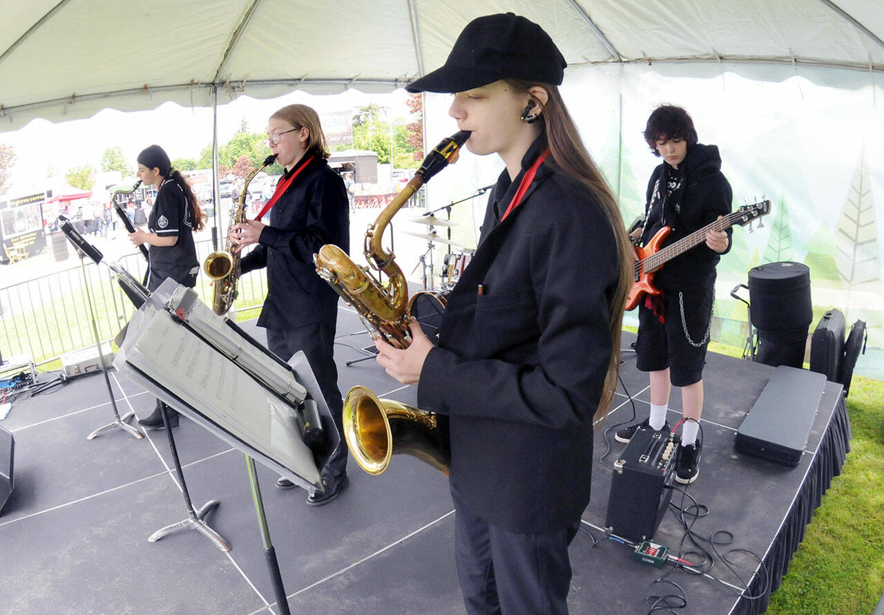 Members of the Crescent High School Jazz Band, from left, Lilly Svenson, Axel Teel, Avery Griffin and Samuel Kitts, perform as Friday’s opening act at the Juan de Fuca Festival of the Arts at Vern Burton Community Center in Port Angeles. Dozens of musical acts, along with food, activities and a craft fair are highlighted across five stages during the three-day festival. (Keith Thorpe/Peninsula Daily News)