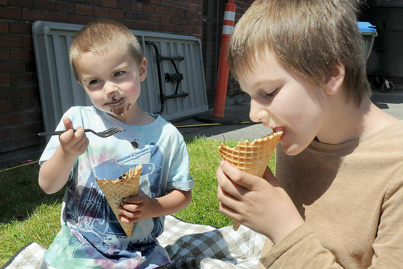 Edmond Mills, 4, and his brother, Avery Mills, 10, both of Port Angeles, enjoy ice cream on Saturday at the Juan de Fuca Festival. (Keith Thorpe/Peninsula Daily News)