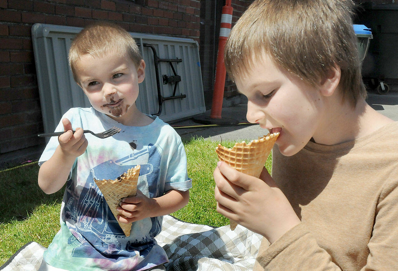 Edmond Mills, 4, and his brother, Avery Mills, 10, both of Port Angeles, enjoy ice cream on Saturday at the Juan de Fuca Festival. (Keith Thorpe/Peninsula Daily News)