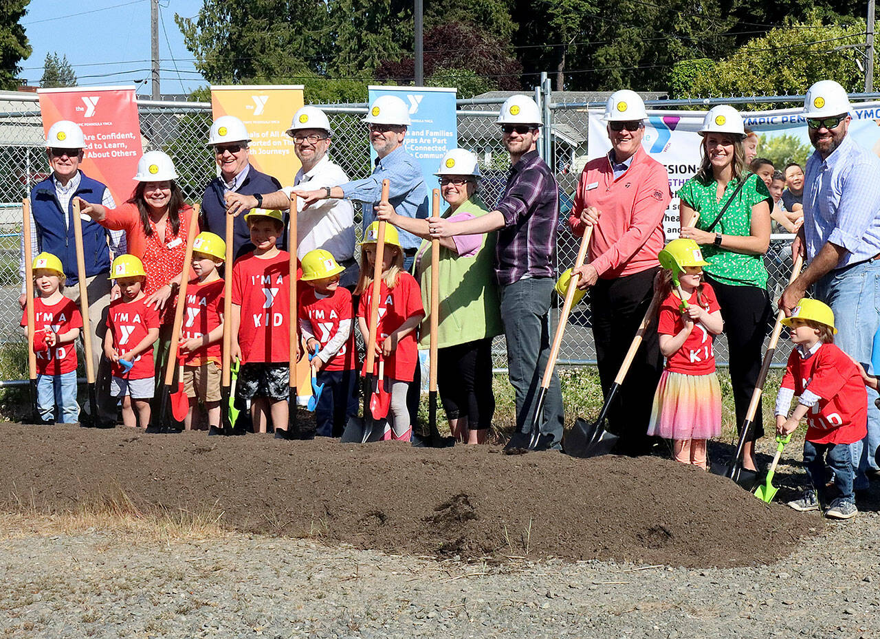 Pictured, left to right, are Randy Johnson, Clallam County Commissioner; Virginia O’Neil, Olympic Peninsula YMCA Board of Directors; Rep. Steve Tharinger, State District 24; Mike French, Clallam County Commissioner; Mark Ozias, Clallam County Commissioner; LaTrisha Suggs, Port Angeles City Council; Drew Schwab, Port Angeles City Council; Glenn Smithson, 7 Cedars Casino General Manager; Lori Robbin, BCRA Design; John Vorhees, GLY Construction — all with assistance from a “Y Kids” crew. (Dave Logan/For Peninsula Daily News)