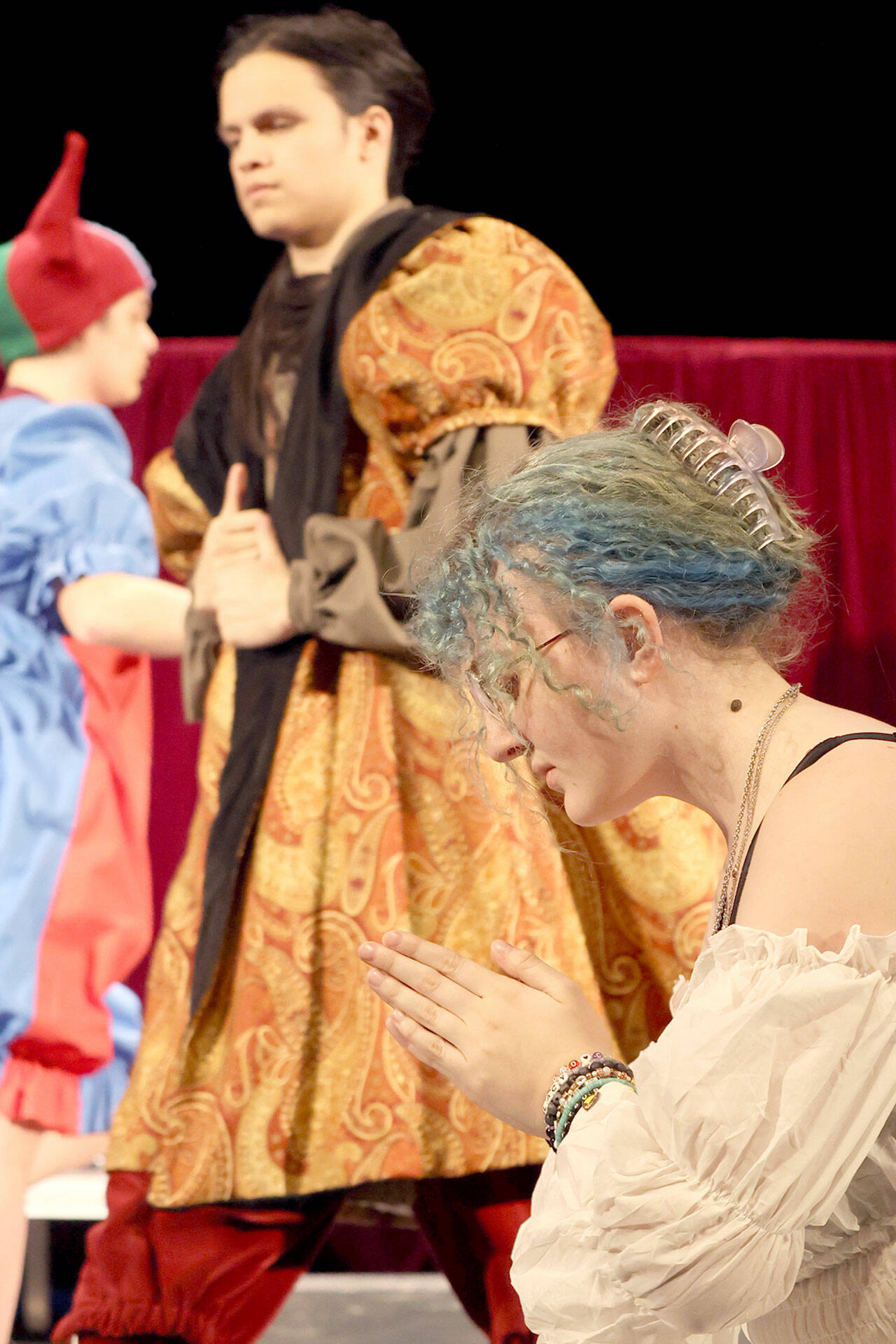 Port Angeles High School senior Madison McIntyre, foreground, will play Catherine of Aragon in “Queens.” Jayden Luabena, also a senior, will play King Henry VIII, and junior Felix Bubb will play the court fool. (Bear Pearcy)