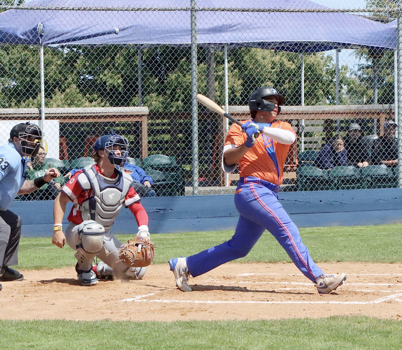 Port Angeles’ Dom Dominguez gets a hit for an RBI against Kamloops at Civic Field on Sunday. (Dave Logan/for Peninsula Daily News)