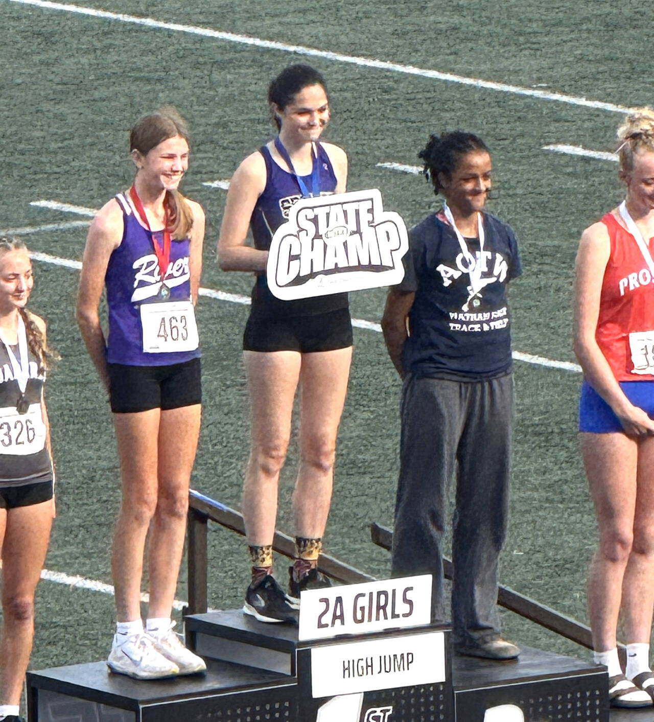 Sequim’s Clare Turella is awarded first place in the state 2A track and field meet at Mount Tahoma Stadium in Tacoma in the girls’ high jump. Turella jumped 5 feet, 4 inches to win the state championship for the second straight year. (Courtesy of Brad Moore)