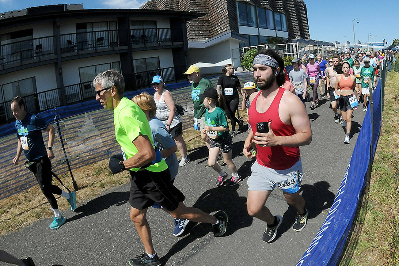 KEITH THORPE/PENINSULA DAILY NEWS
Runners take off from the start of Saturday's combined 5k and 10k races of the Olympic Discovery Marathon along the Waterfront Trail from Port Angeles City Pier,