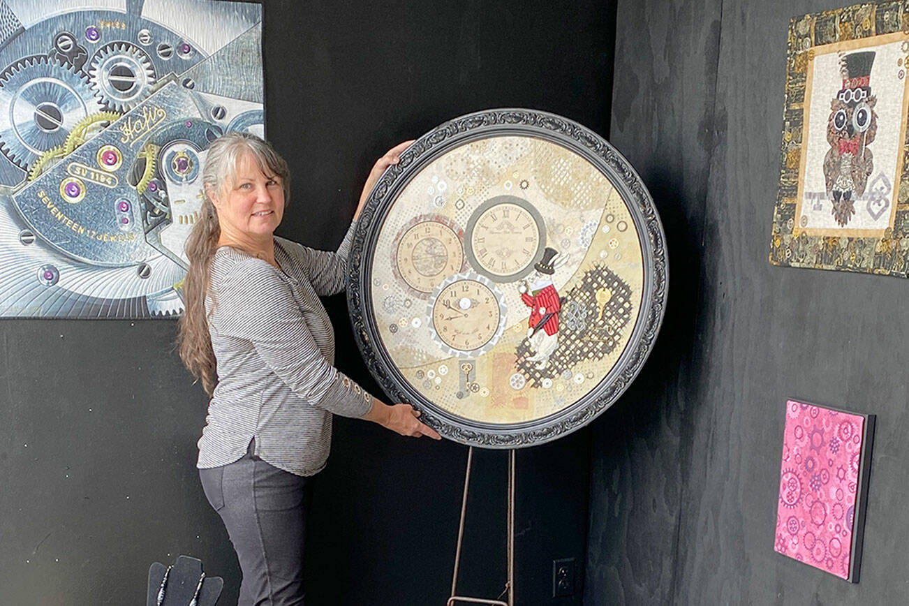 Fiber artist Angie Dideum installs the “Steampunk in Fiber” exhibit in Uptown Port Townsend.