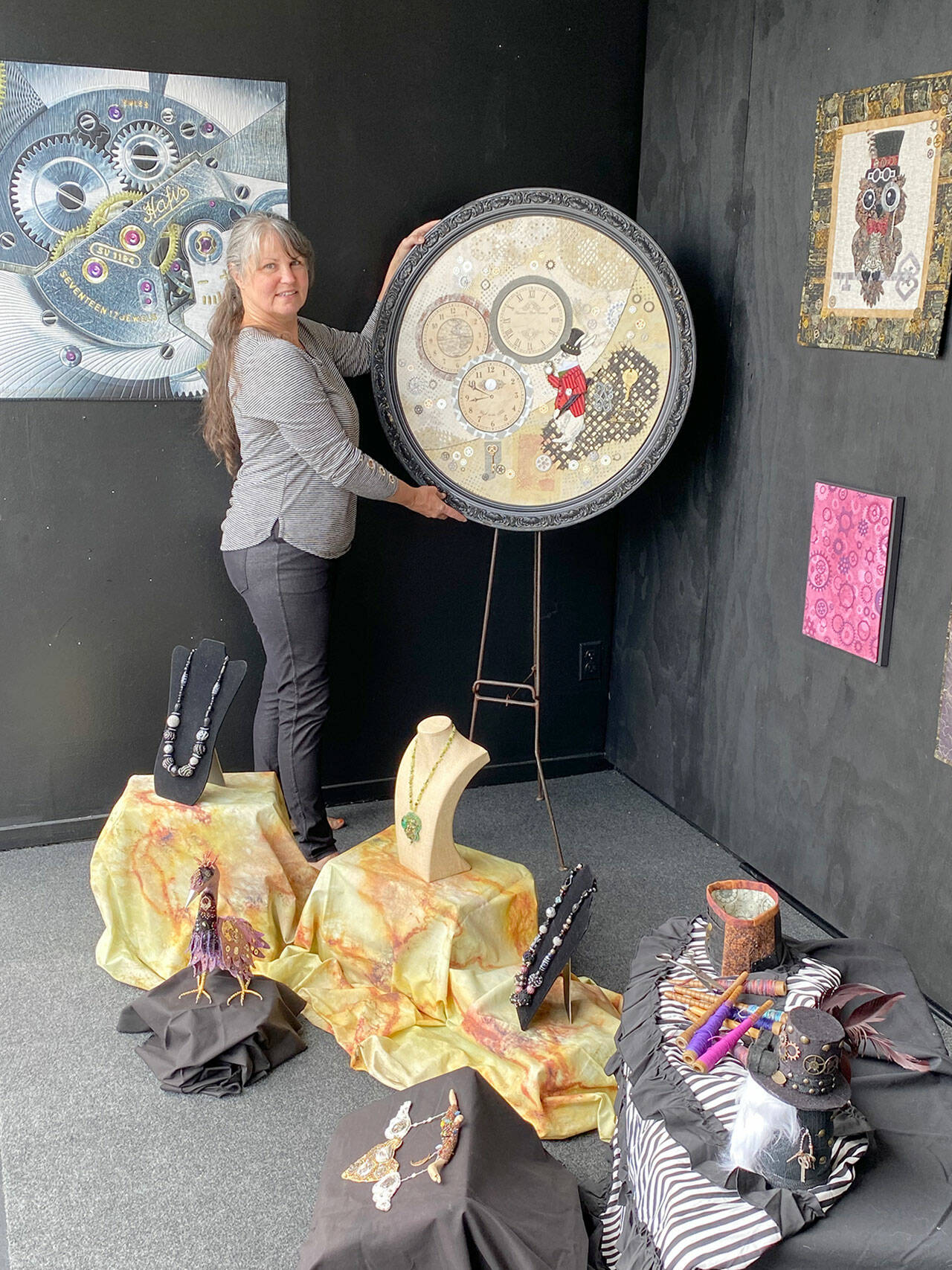 Fiber artist Angie Dideum installs the “Steampunk in Fiber” exhibit in Uptown Port Townsend.