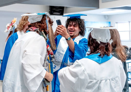 Chimacum High School senior Jesse Daniels takes crazy cell phone photos of his classmates while waiting to march to the gym for his graduation ceremony at Chimacum High on Saturday. (Steve Mullensky/for Peninsula Daily News)