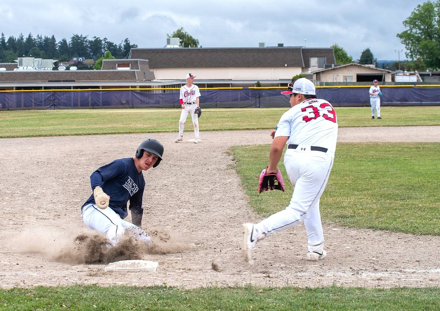 Wilder Junior’s Hunter Tennell slides into third base against the WBS Colts in Sequim on Friday. (Emily Mathiessen/Olympic Peninsula News Group)
