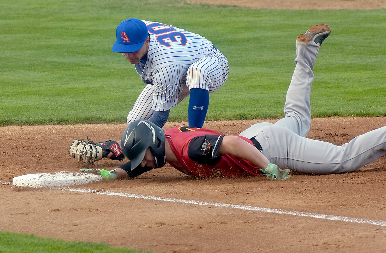 KEITH THORPE/PENINSULA DAILY NEWS 
Lefties first baseman Will White tries to catch Seattle Gumberoos baserunner Eoin Buechs off the bag during a June game at Port Angeles Civic Field. White had three hits in Port Angeles’ 16-7 win over Edmonton.