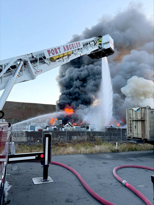 Firefighters work to extinguish a fire at the Port Angeles transfer station on Sunday. (Port Angeles Fire Department)
