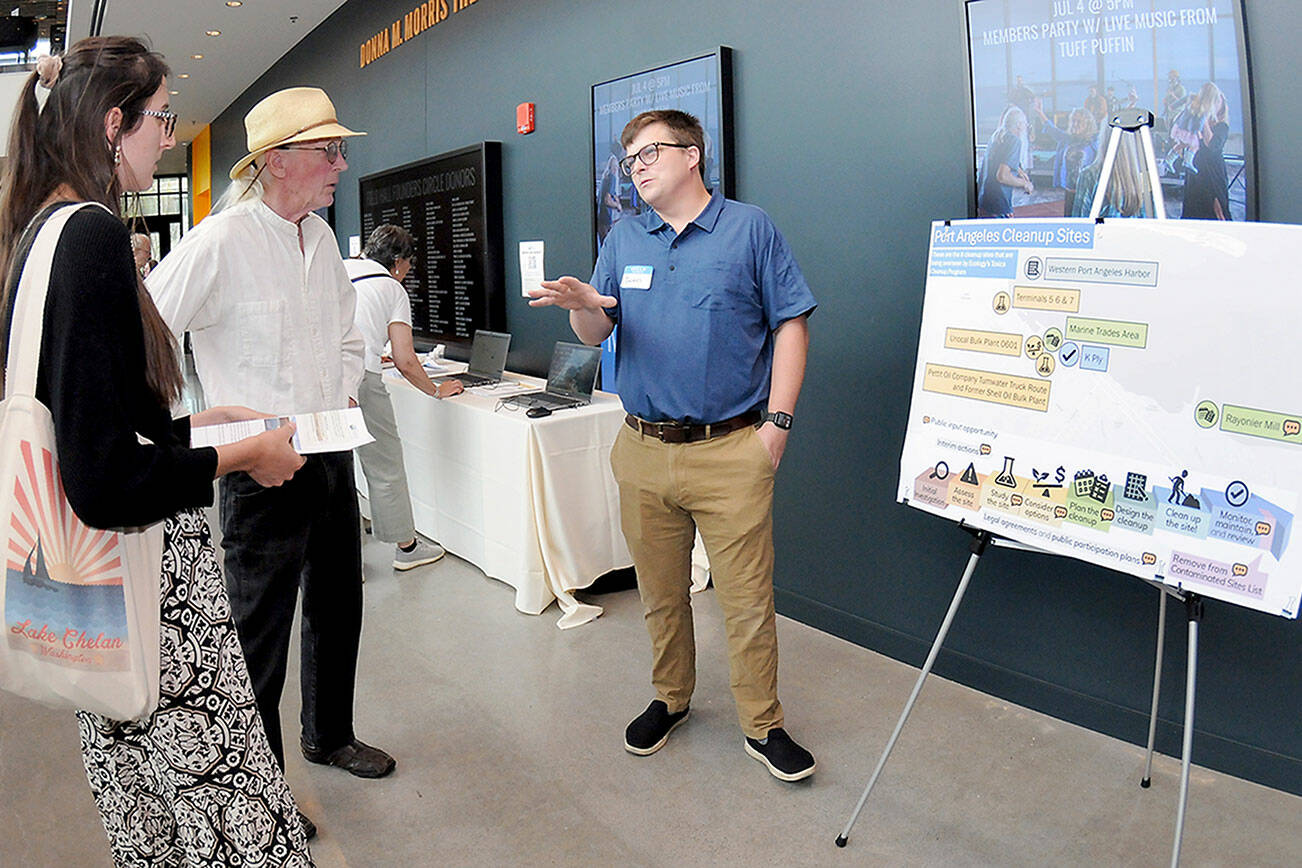 KEITH THORPE/PENINSULA DAILY NEWS
Thomas Praisewater, a site manager with the Washington Dept. of Ecology, right, discusses environmental cleanup sites with Madelynne Jones, left, and Thomas Beatty, both of Port Angeles, during an open house on the status cleanup of the former Rayonier mill site on Tuesday at the Field Arts & Events Hall.