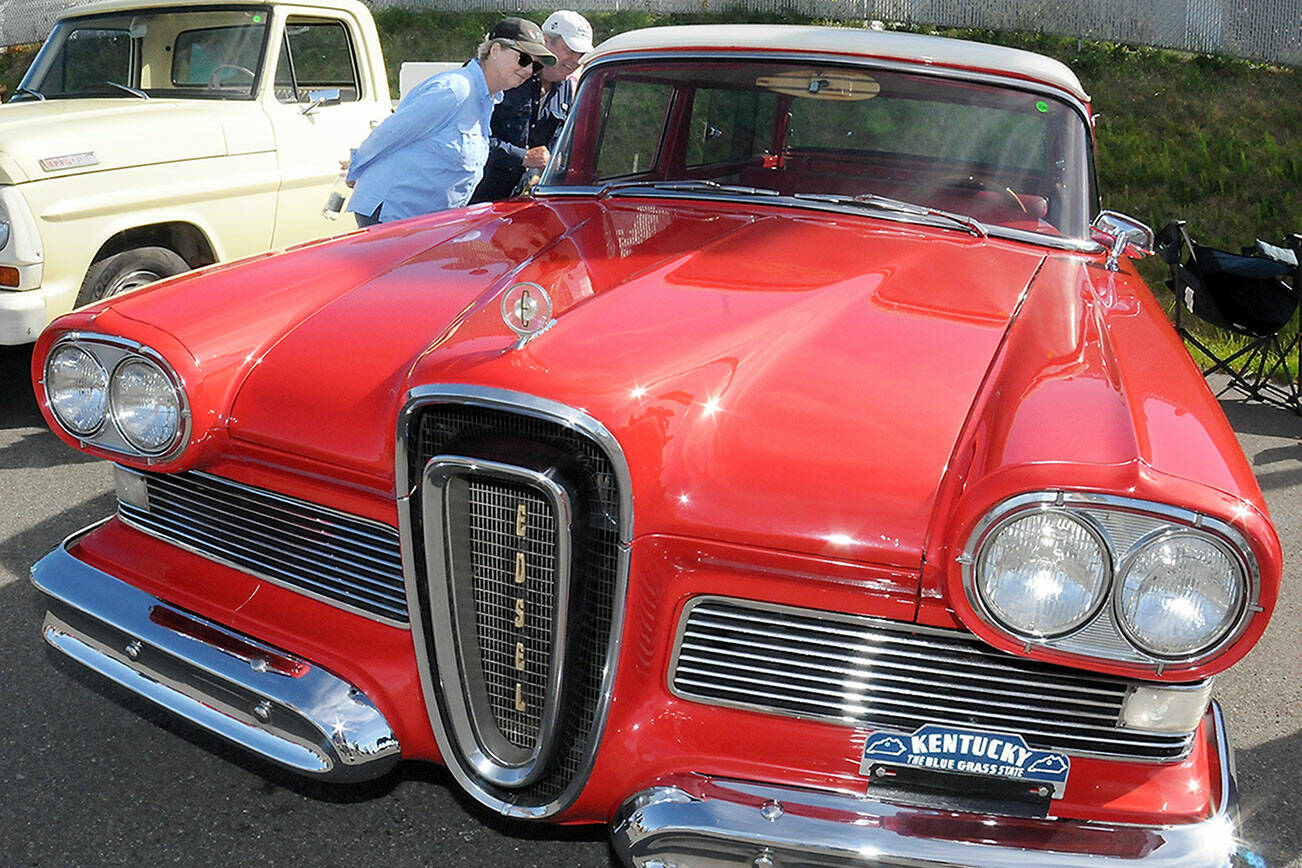 Kelly and Dan Freeman of Port Ludlow examine a 1958 Edsel on display during Friday evening’s 29th annual Ruddell Cruise-In at Ruddell Auto in Port Angeles. The event featured hundreds of antique and vintage automobiles from across the region as well as food, music and other activities. (Keith Thorpe/Peninsula Daily News)