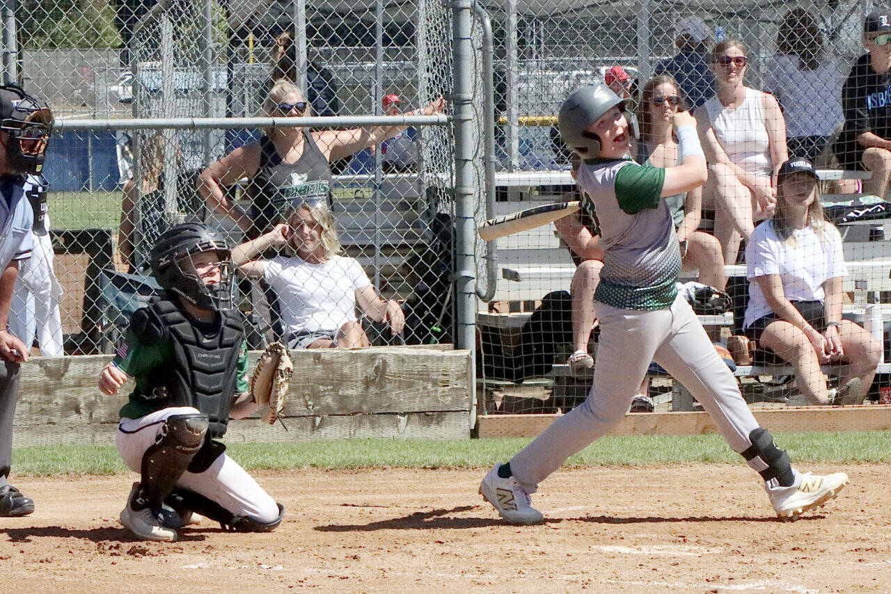 Port Angeles U11’s Mason Henderson hits a RBI to right field as the local team played the Lynden Lobos in the championship game, falling 9-5. (Dave Logan/for Peninsula Daily News)