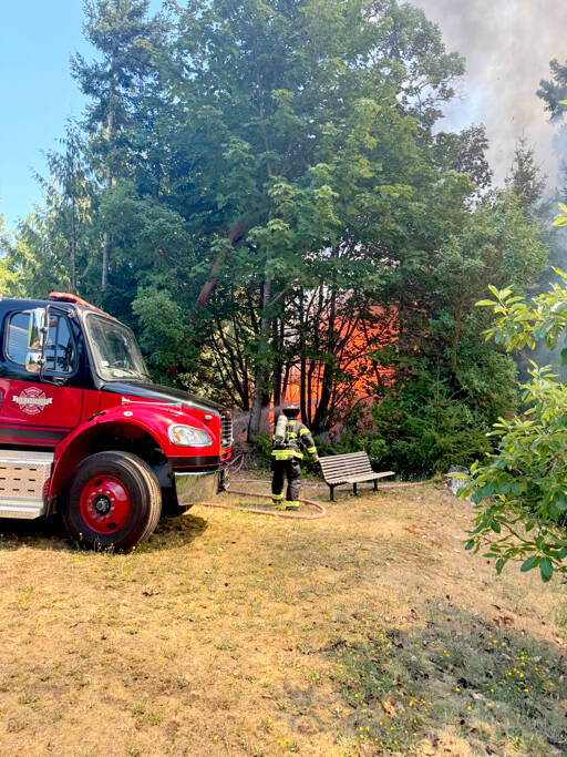 Firefighters work to contain a wildland fire on Tuesday afternoon near Brinnon. “Go now” evacuation orders were given from Jefferson County’s Emergency Operations Center. (Jefferson County Sheriff’s Office)