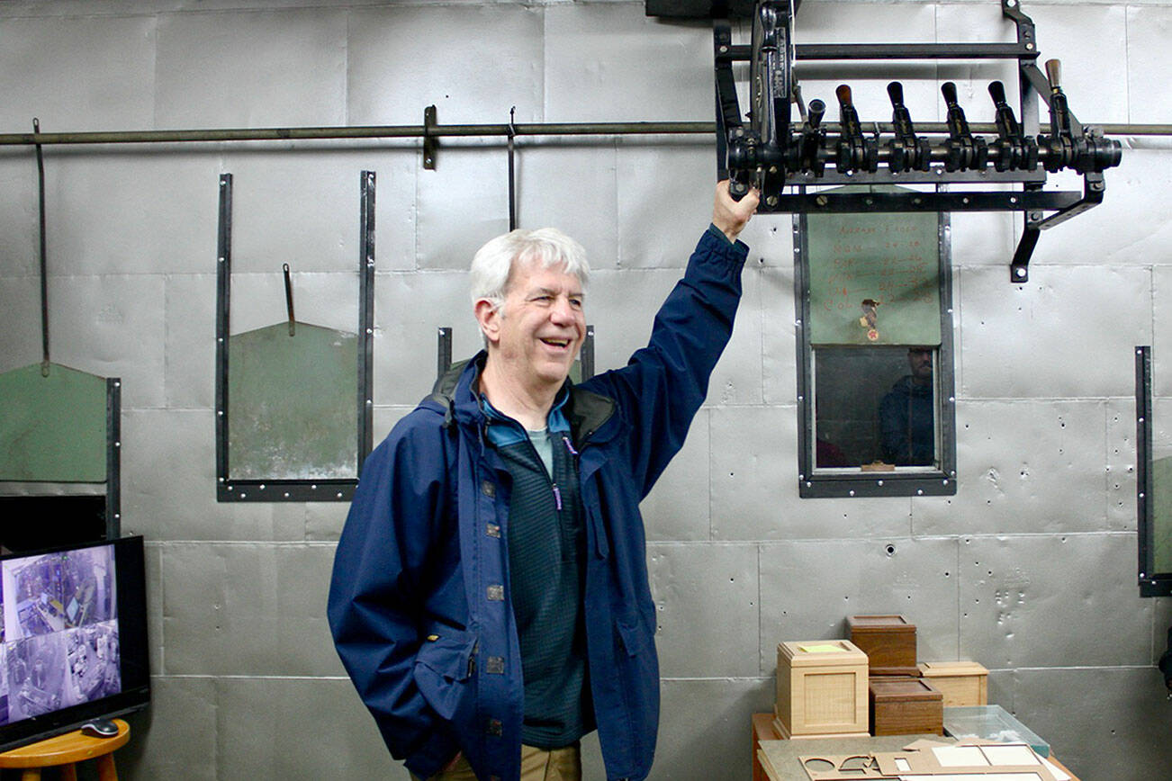 Tour guide Steve Hargis shares the history of a long-forgotten movie theater hidden above Captain T’s, offering a glimpse into Port Angeles’ early entertainment scene. (Allora Walls/Peninsula Daily News)