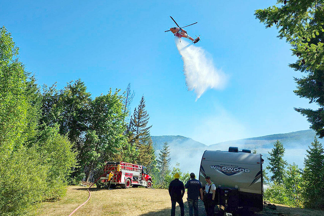 A helicopter joins the firefighting effort Tuesday afternoon at the Belgian Fire near Brinnon. (Brinnon Fire Department)