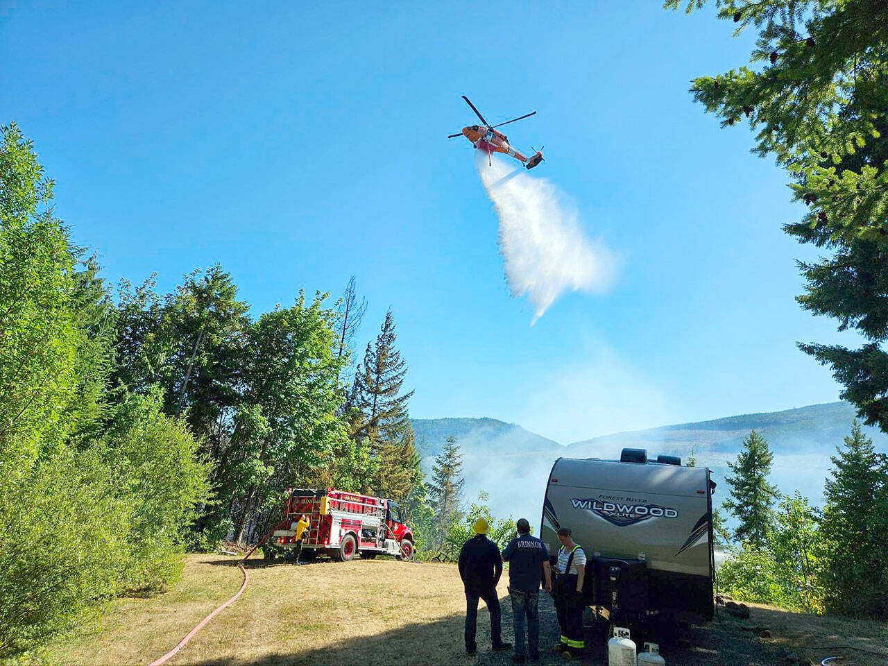 A helicopter joins the firefighting effort Tuesday afternoon at the Belgian Fire near Brinnon. (Brinnon Fire Department)