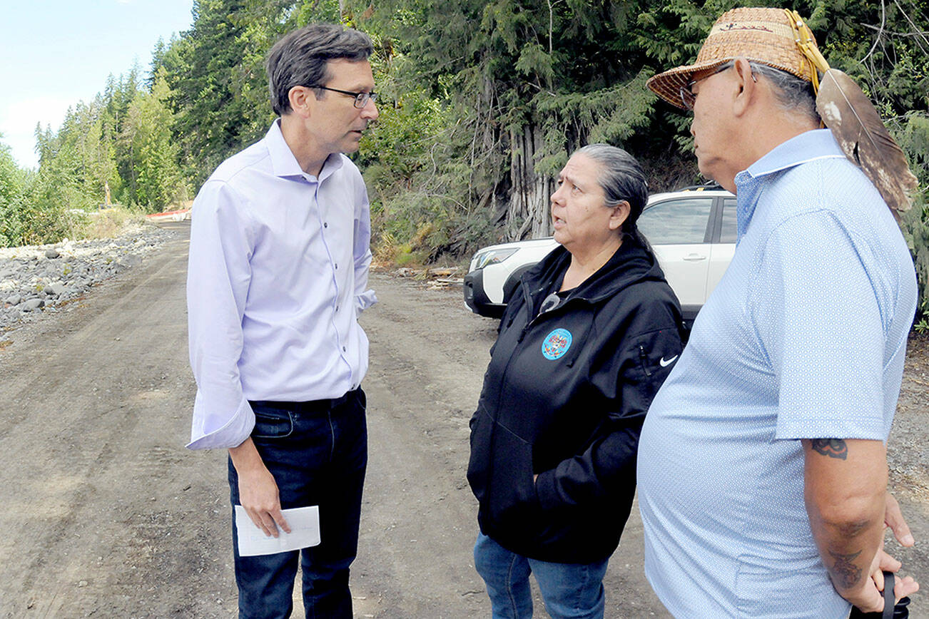 Gov. Bob Ferguson, left, speaks with Lower Elwha Klallam Tribal Chairwoman Frances Charles and Vice Chair Russ Hefner before a news conference on Sunday at the confluence of Indian Creek and the Elwha River after a fuel spill into the creek on Friday forced a shutdown of the Port Angeles municipal water system. (Keith Thorpe/Peninsula Daily News)