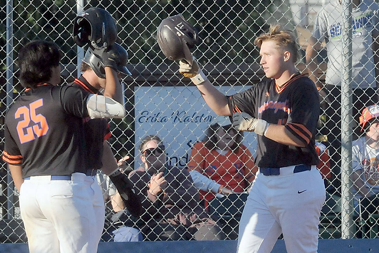KEITH THORPE/PENINSULA DAILY NEWS
Lefties third baseman Ty Thomas, right, is greeted at the plate by teammates Dom Dominguez, left, and Jeremy Giesegh after Thomas slugged a two-run homer in the third inning against Bellingham on Wednesday evening in Port Angeles.