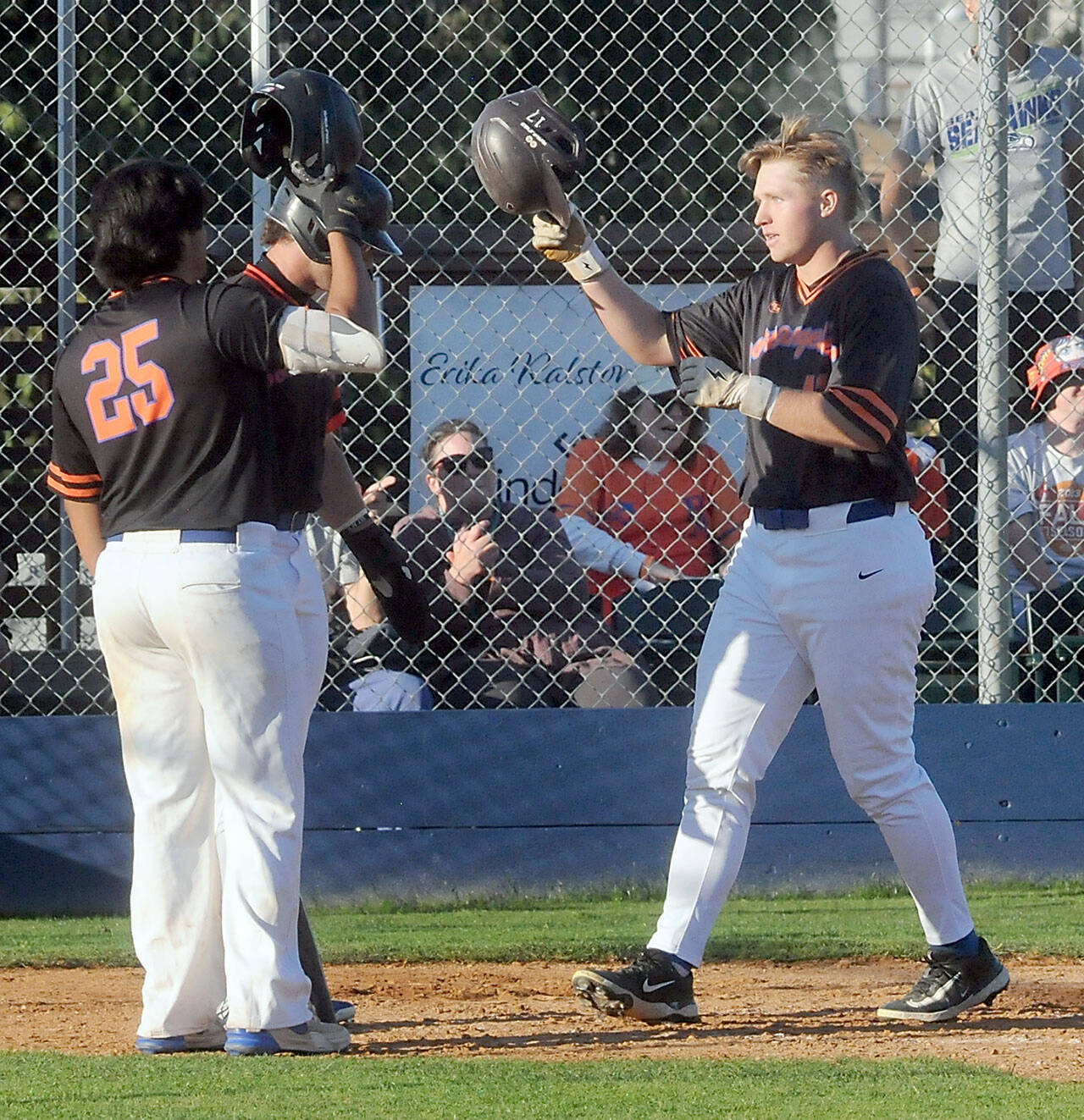 Lefties third baseman Ty Thomas, right, is greeted at the plate by teammates Dom Dominguez, left, and Jeremy Giesegh after Thomas slugged a two-run homer in the third inning against Bellingham on Wednesday evening in Port Angeles. (Keith Thorpe/Peninsula Daily News)