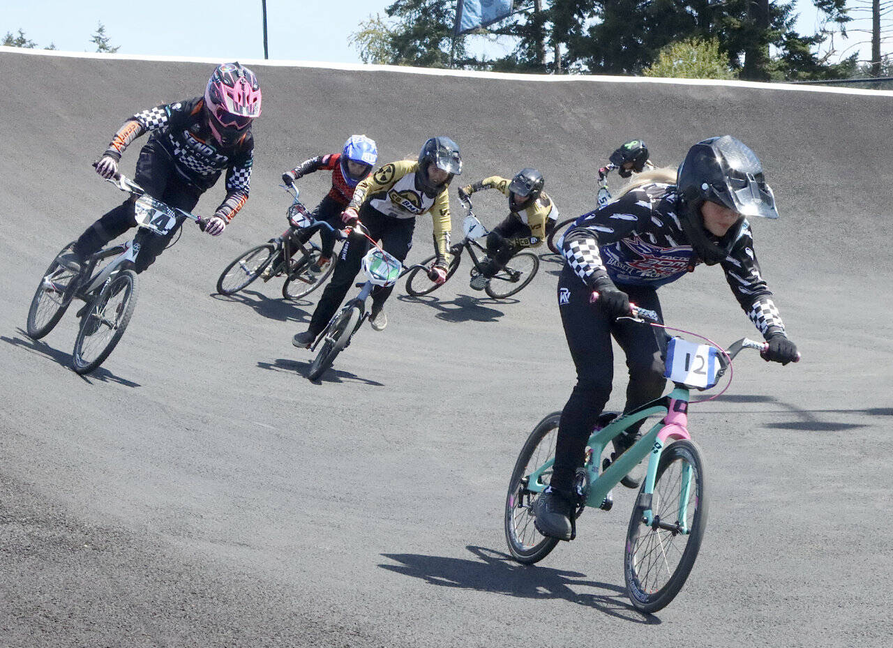 More than 430 riders from all over the state came to race at the Lincoln Park BMX track for a triple-point state qualifier. Here, Sophia McCain of Spokane (12), Chloe Maxfield of Port Angeles (14) and Addyson Cameron of Pasco (10) lead the large field of 12 and under girls Sunday. The state championships will be held in September in Spokane. Meanwhile, five riders from the Lincoln Park BMX are racing in the world championships in Copenhagen, Denmark this week. (Dave Logan/for Peninsula Daily News)