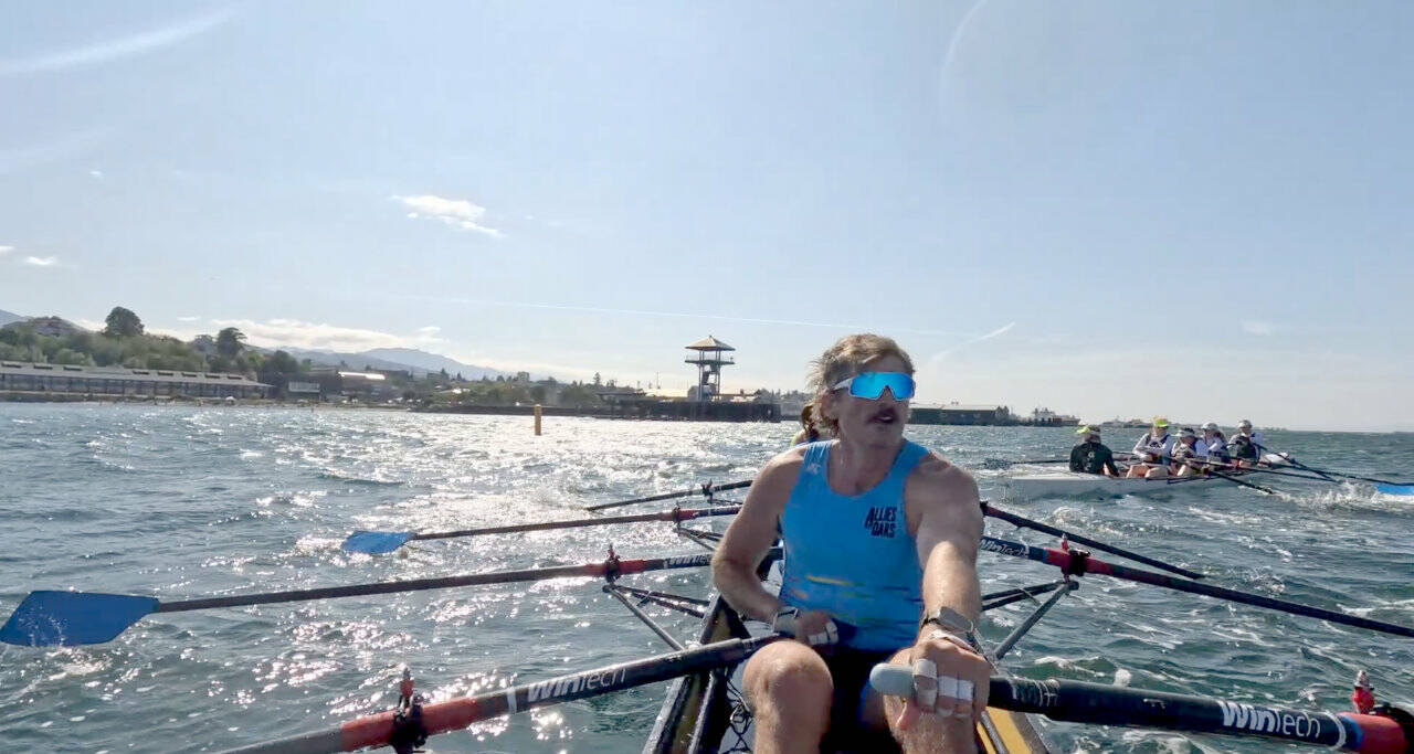 The A final of the coxed quad of the Port Angeles coastal beach sprint regatta pitted the Pocock Rowing Club team of Logan Fink (foreground), Randall Sigle, Hank Koerner, Rachel Egner and Seamin Kim against the Green Lake team of Georgia Legere, Emily Gascho, Christine Legere, Natalie Lecher and Jeff Pozarski. Pocock won with a time of 3:50.2. The teams are seen completing the 180 degree turn 250 meters from shore. (OPRA)