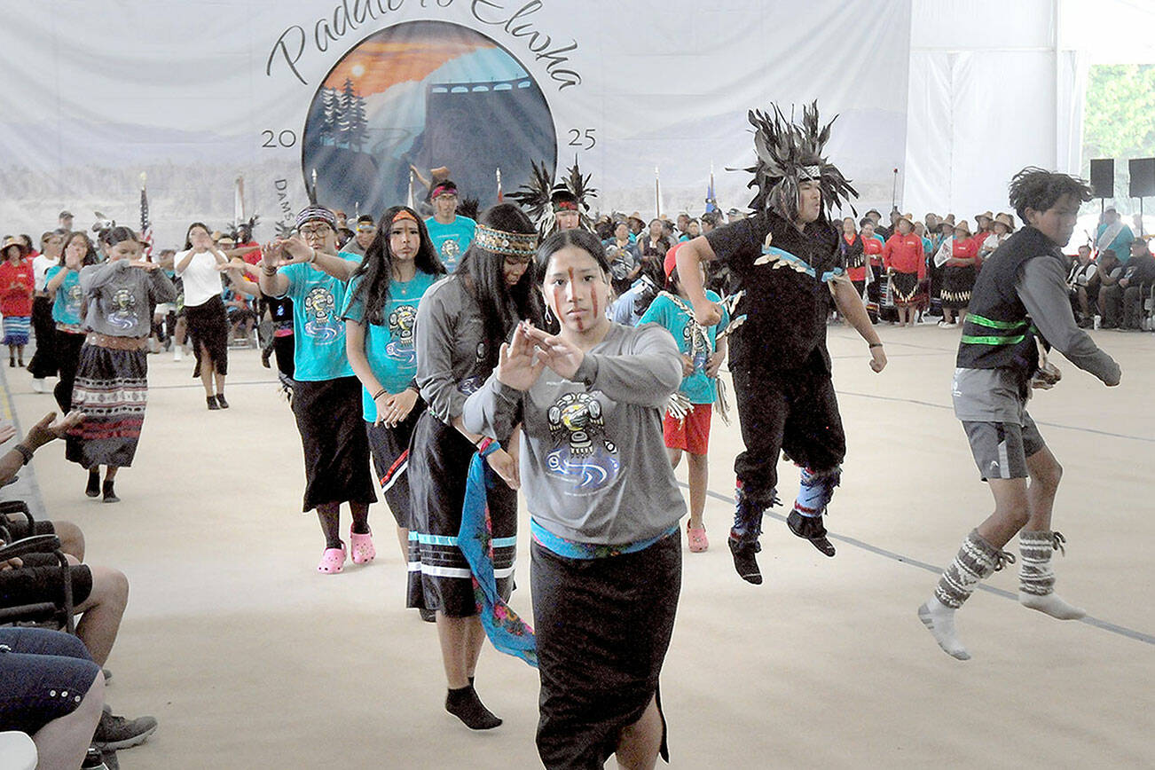 Members of the Cheam First Nation of Rosedale, British Columbia, perform a canoe dance during Friday’s first full day of dancing and protocols for visiting native groups to Paddle to Elwha 2025 on the Lower Elwha Klallam reservation west of Port Angeles. Native bands from across the region are taking part in the event, which will continue through Tuesday. (Keith Thorpe/Peninsula Daily News)