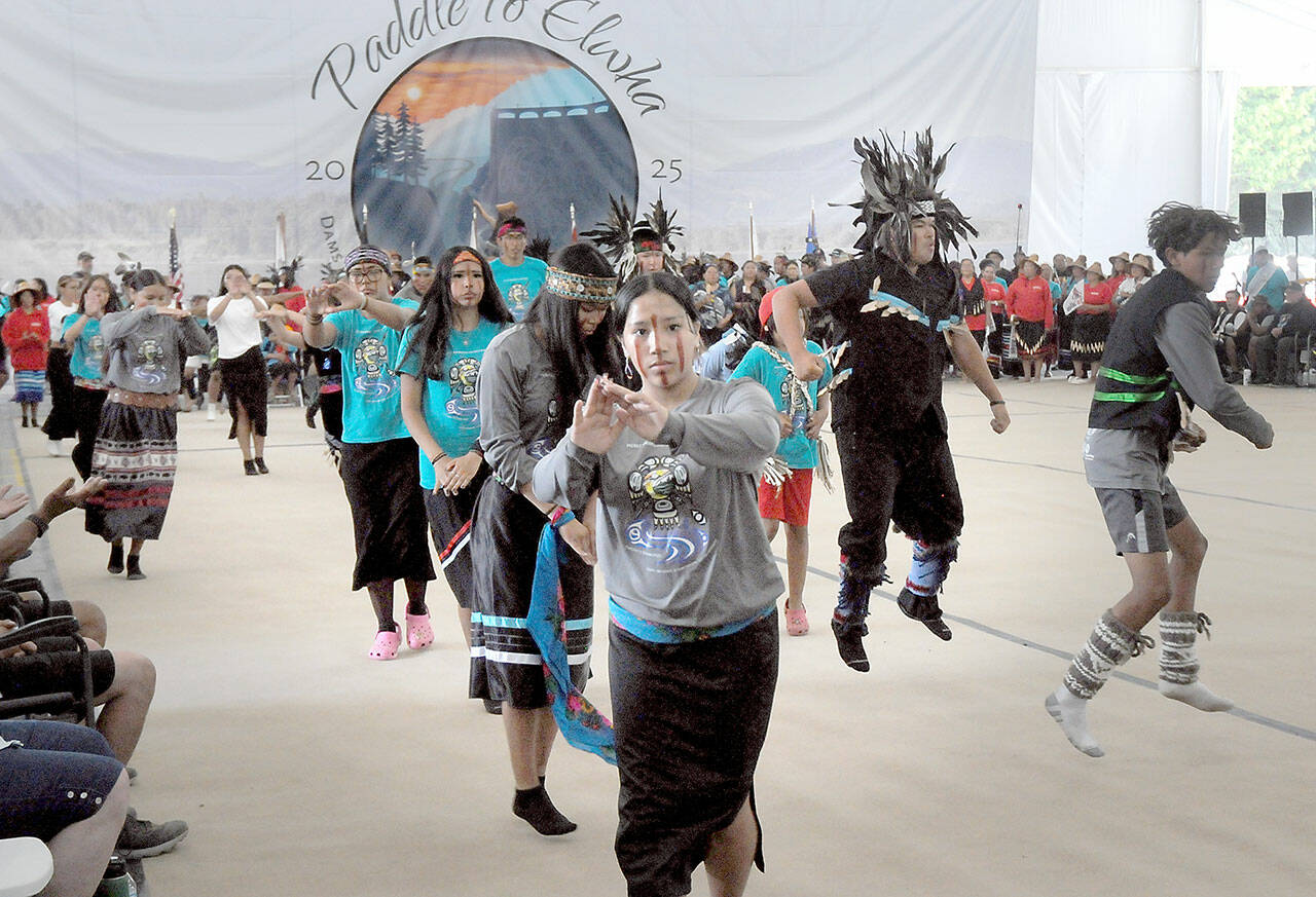 Members of the Cheam First Nation of Rosedale, British Columbia, perform a canoe dance during Friday’s first full day of dancing and protocols for visiting native groups to Paddle to Elwha 2025 on the Lower Elwha Klallam reservation west of Port Angeles. Native bands from across the region are taking part in the event, which will continue through Tuesday. (Keith Thorpe/Peninsula Daily News)