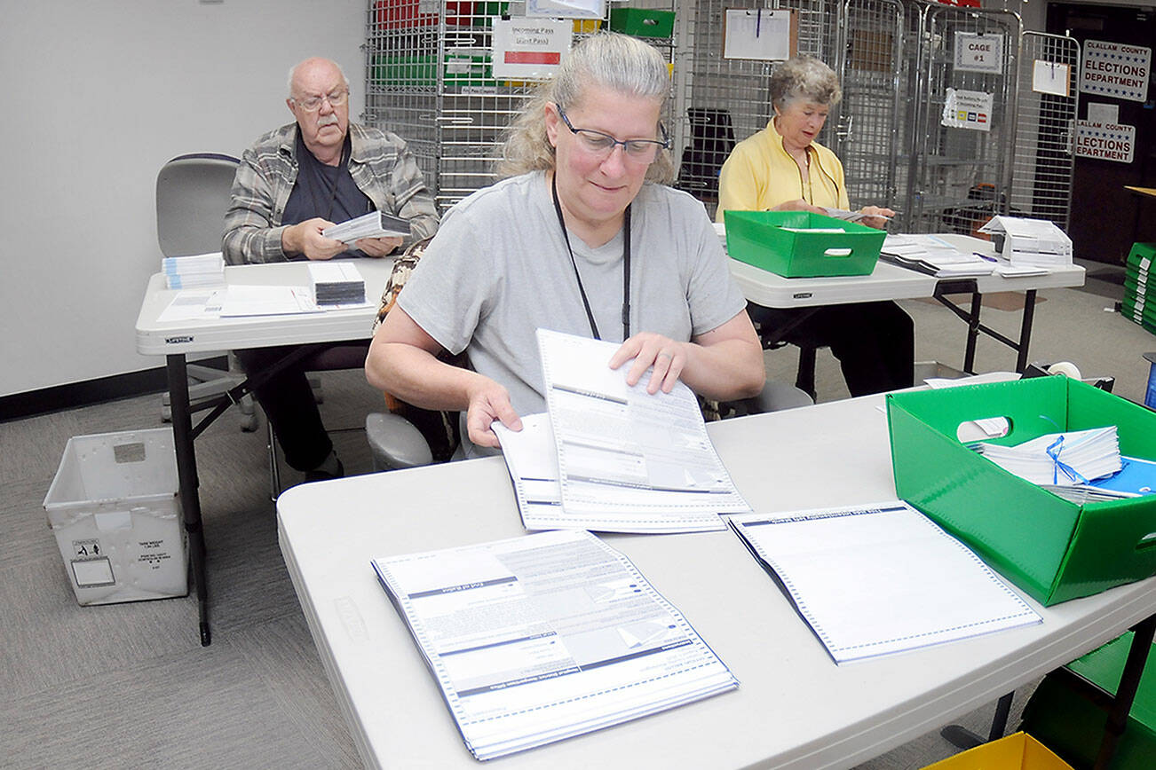 Clallam County election workers Shellie Andrews of Port Angeles, front, Ray Farrell of Forks, left, and Kathy Schreiner of Sequim organize ballots on Tuesday at the Clallam County Courthouse. Primary election results from Tuesday night are at www.peninsuladailynews.com, and coverage of the election will be in Thursday’s print edition. (Keith Thorpe/Peninsula Daily News)