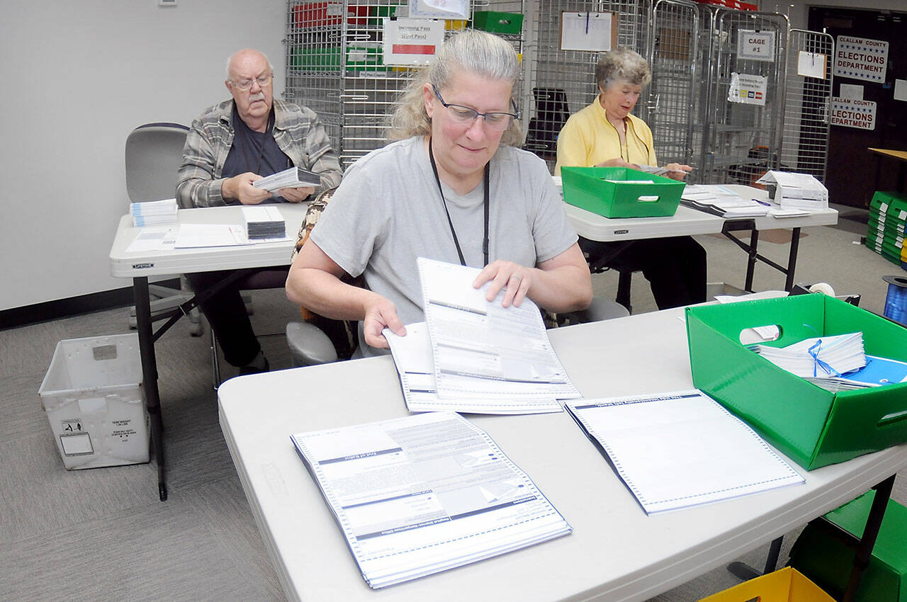 Clallam County election workers Shellie Andrews of Port Angeles, front, Ray Farrell of Forks, left, and Kathy Schreiner of Sequim organize ballots on Tuesday at the Clallam County Courthouse. Primary election results from Tuesday night are at www.peninsuladailynews.com, and coverage of the election will be in Thursday’s print edition. (Keith Thorpe/Peninsula Daily News)