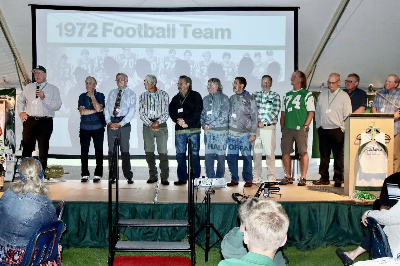 The 7th annual Port Angeles Hall of Fame induction ceremony was held Saturday night on the grass at Civic Field. More than 350 people attended the event held under a tent. Nine individuals were inducted as well as three teams — the 1977 girls basketball, 1972 football, and 1952 boys basketball teams. The nine individuals were Bob Blackburn, track; Mike Chamberlin, swimming; Gus Kravas, basketball; Steve Johansen, basketball; Jodie Jones, softball; Bob Lovell, football; Adam Macomber, football; Bob Spencer, swimming; and Susan Wilson Childers, badminton. Here, Jerry Payne, far left, speaks for the 1972 football team that was ranked as high as fifth in the state and had seven shutouts in 10 games. (Photos by Dave Logan/for Peninsula Daily News)