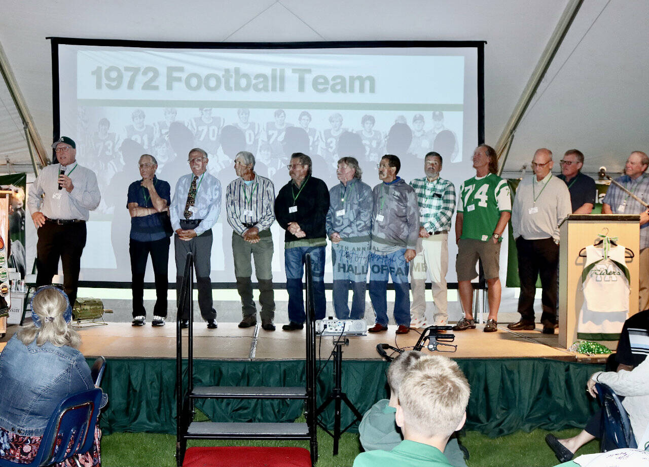 The 7th annual Port Angeles Hall of Fame induction ceremony was held Saturday night on the grass at Civic Field. More than 350 people attended the event held under a tent. Nine individuals were inducted as well as three teams — the 1977 girls basketball, 1972 football, and 1952 boys basketball teams. The nine individuals were Bob Blackburn, track; Mike Chamberlin, swimming; Gus Kravas, basketball; Steve Johansen, basketball; Jodie Jones, softball; Bob Lovell, football; Adam Macomber, football; Bob Spencer, swimming; and Susan Wilson Childers, badminton. Here, Jerry Payne, far left, speaks for the 1972 football team that was ranked as high as fifth in the state and had seven shutouts in 10 games. (Photos by Dave Logan/for Peninsula Daily News)