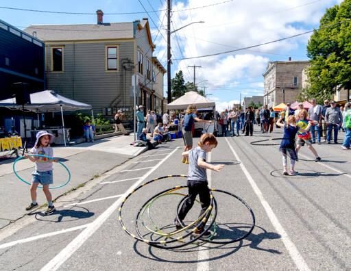 Quinn Early, 6, of Port Townsend, spins five hula hoops at once during the 33rd Uptown Port Townsend Street Fair on Saturday. (Steve Mullensky/for Peninsula Daily News)