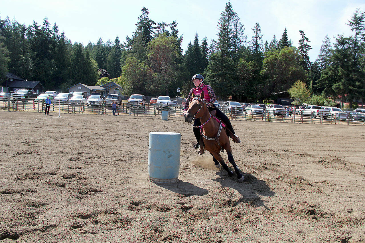 Photo by Karen Griffiths
At the JeffCo fair Future Farmers of America member Ivy Pettit and her horse Kohana completed a fast burn-n-turn in the youth barrel racing competition.