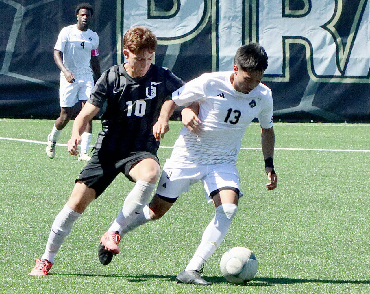 Peninsula College’s Ezrah Ochoa battles for a ball against a defender from Wenatchee Valley on Thursday. In the background is Jeremie Kuelo. Ochoa scored 14 goals for the Pirates last season and is expected to be one of the team’s top offensive weapons this season. (Dave Logan/for Peninsula Daily News)