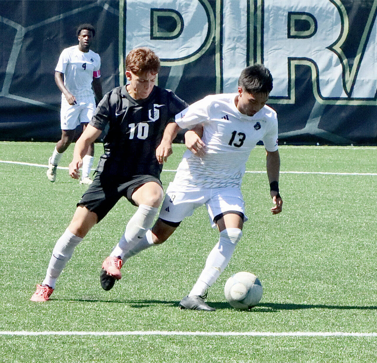 Peninsula College’s Ezrah Ochoa battles for a ball against a defender from Wenatchee Valley on Thursday. In the background is Jeremie Kuelo. Ochoa scored 14 goals for the Pirates last season and is expected to be one of the team’s top offensive weapons this season. (Dave Logan/for Peninsula Daily News)