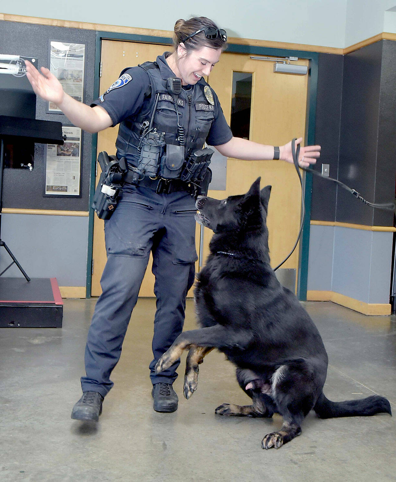 Port Angeles Police Officer Whitney Fairbanks plays with her dog Copper during a presentation in September 2024. (Keith Thorpe/Peninsula Daily News)