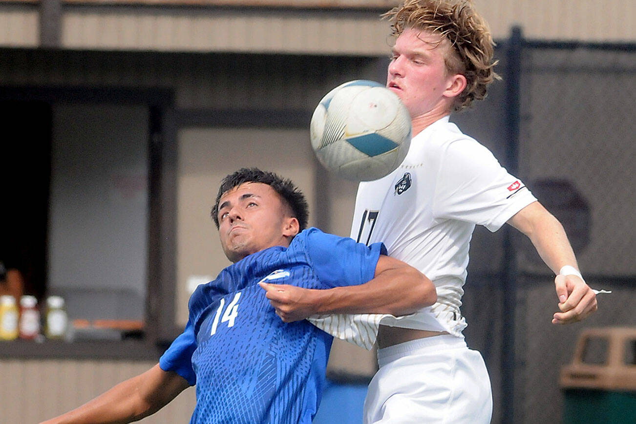 KEITH THORPE/PENINSULA DAILY NEWS
Rogue's Andre Estanoqui, left, and Peninsula's Max Pieper battle for control on Friday afternoon in Port Angeles.