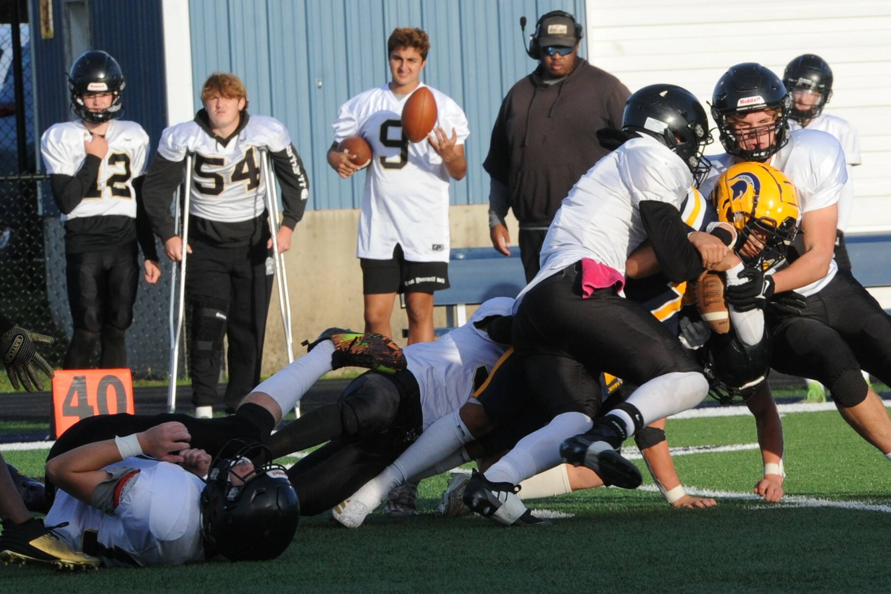 Lonnie Archibald/for Peninsula Daily News
Forks' Estevan Ramos (yellow helmet) is wrapped up by a host of Meridian tacklers during 2024 contest in Forks. Buoyed by offseason training, the Spartans aim is to improve upon a difficult 2024 campaign.