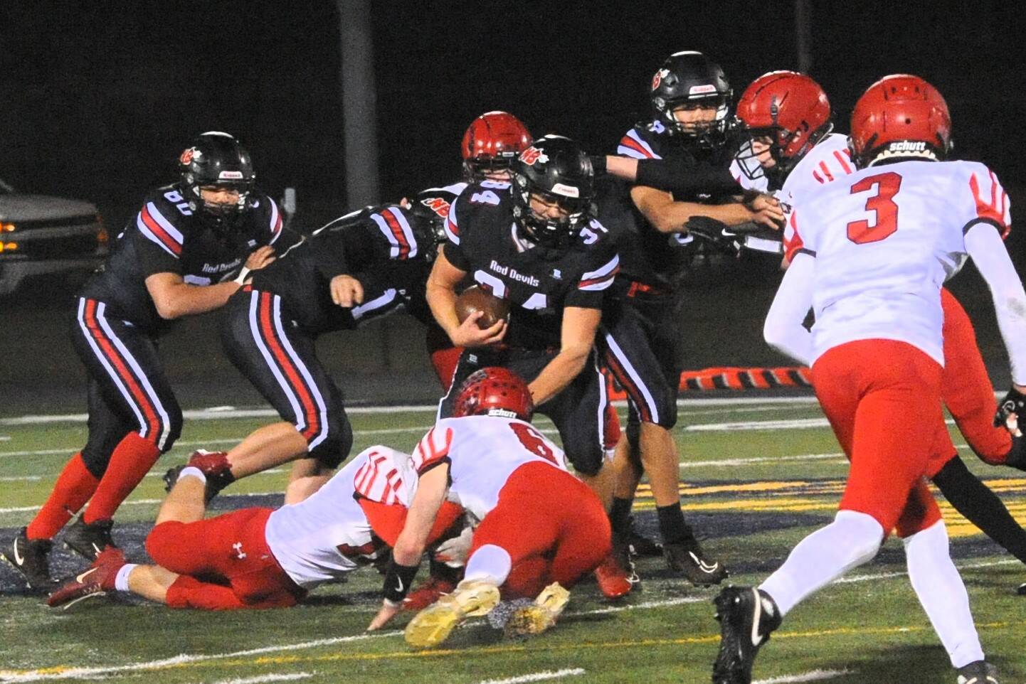 Lonnie Archibald/for Peninsula Daily News
Neah Bay’s Tyler Swan (34) picks up yardage against Wahkiakum on the turf of Spartan Stadium in Forks in a 2024 state playoff contest. Swan is expected to be a big part of the Red Devils’ offense this year.