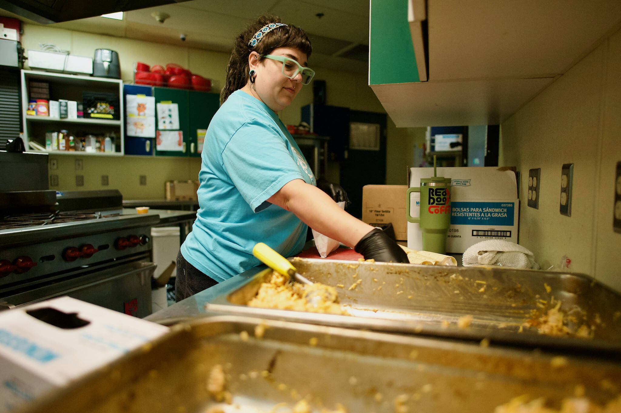 Kat Malcom, child nutrition director for the Sequim Boys & Girls Club, prepares chicken enchilada wraps for distribution to children throughout Sequim. During the months of June and July, the Boys & Girls Clubs of the Olympic Peninsula provided more than 16,000 meals and snacks to children in Sequim and Port Angeles. (Jacques Star/Olympic Peninsula News Group)