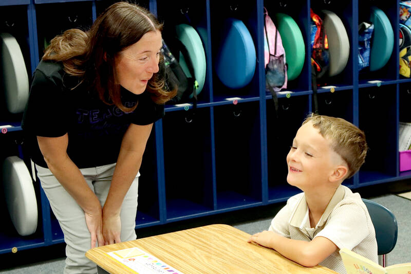Jefferson Elementary School first-grade teacher Pamela Miller welcomes Ethan Puderbaugh to the classroom as school started Tuesday in the Port Angeles School District. Port Townsend and Chimacum schools also began Tuesday while classes in the Quillayute Valley and Cape Flattery school districts start today. The Quilcene and Brinnon school districts began Aug. 25 while Sequim and Crescent schools began Aug. 27. (Dave Logan/for Peninsula Daily News)
