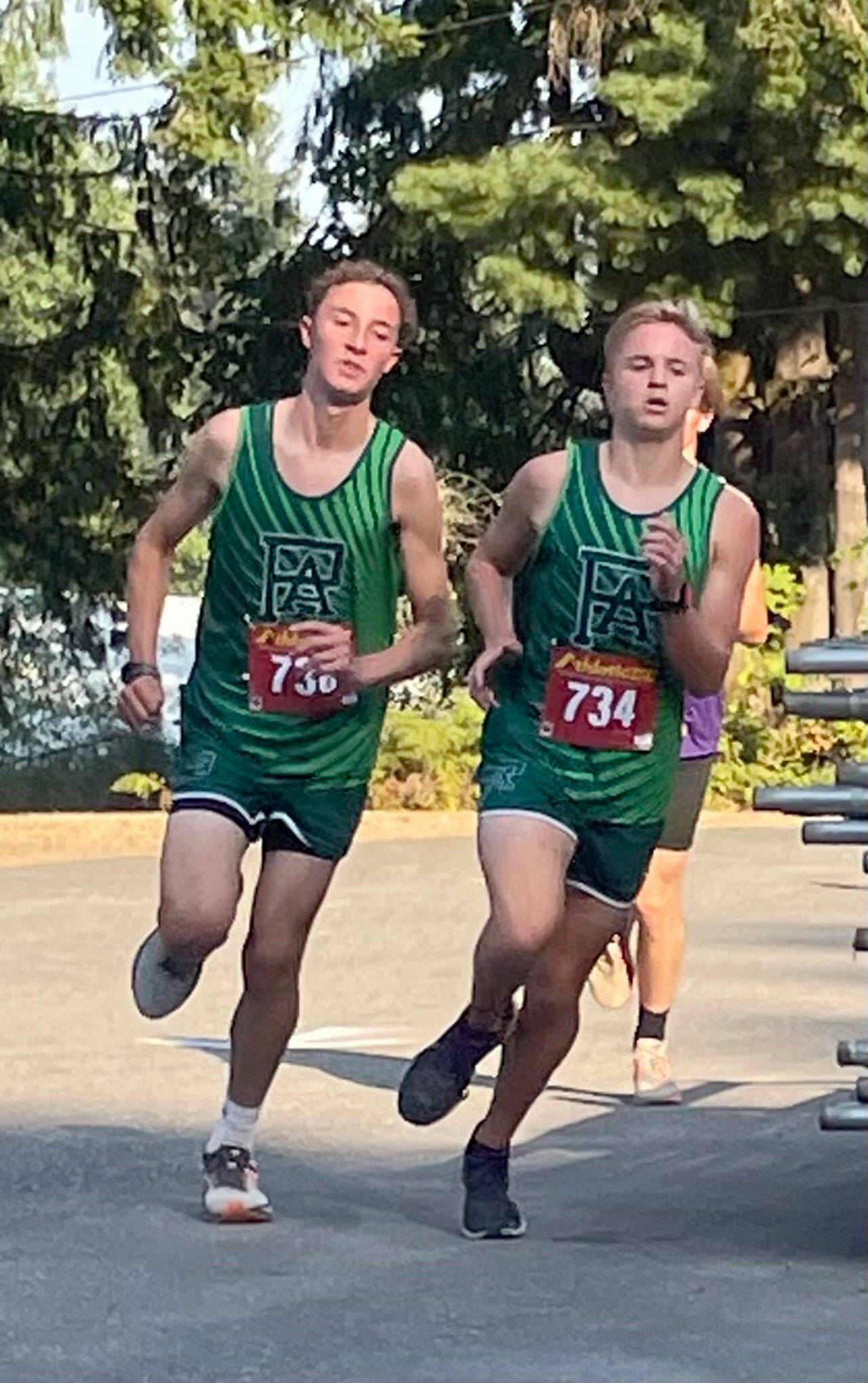 Port Angeles Cross Country Port Angeles runners Henry Wendell and Justin McClarty run during the Olympic League Cross Country Jamboree at Kitsap County Fairgrounds on Wednesday.