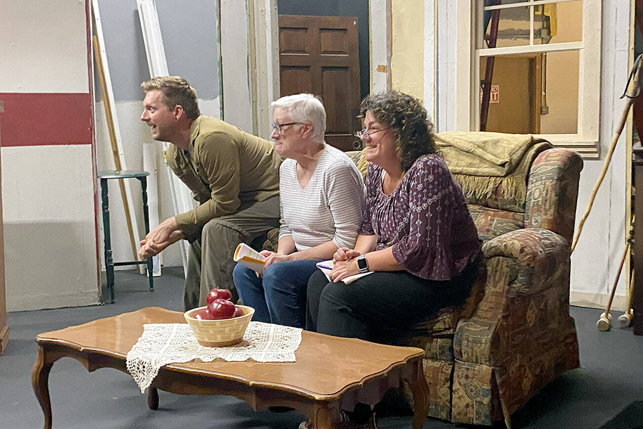 Port Angeles residents, from left, Justin Stapleton, Mary Kaye O'Brien and Jenifer Saul rehearse on the unfinished set of "The Foreigner."