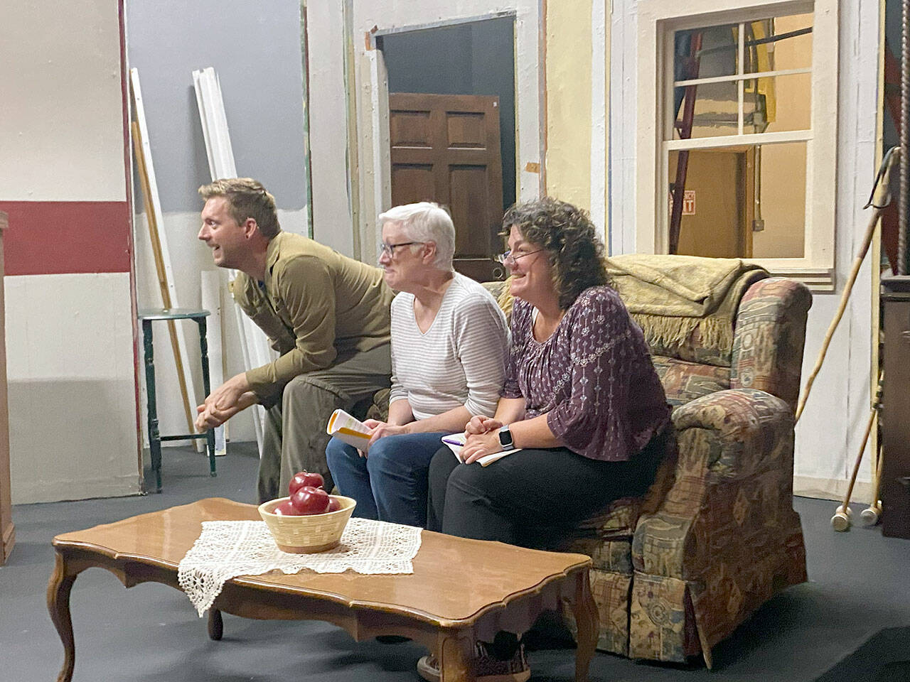 Port Angeles residents, from left, Justin Stapleton, Mary Kaye O'Brien and Jenifer Saul rehearse on the unfinished set of "The Foreigner."